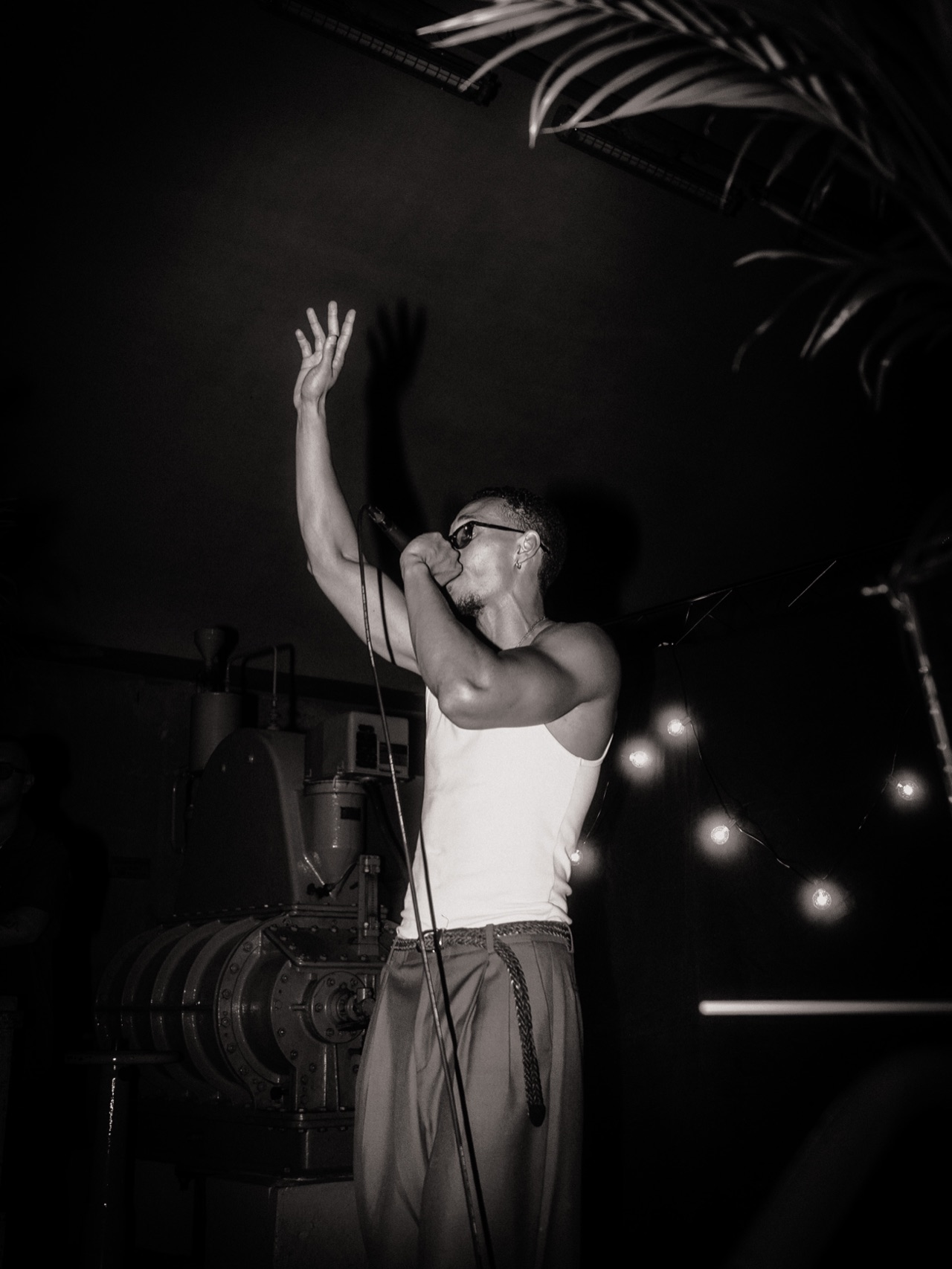 SELAH live on stage with one hand raised, black and white
