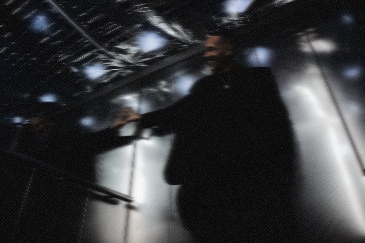 Motion-blurred silhouette of SELAH against ceiling lights